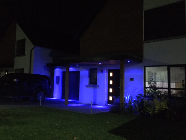 Blue soffit lights over front door & garage.